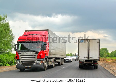 TATARSTAN, RUSSIA - MAY 29, 2013: Red Scania P360 semi-trailer truck at the interurban road.
