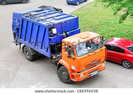 UFA, RUSSIA - MAY 28, 2012: Orange KAMAZ 53605 garbage truck at the city street.