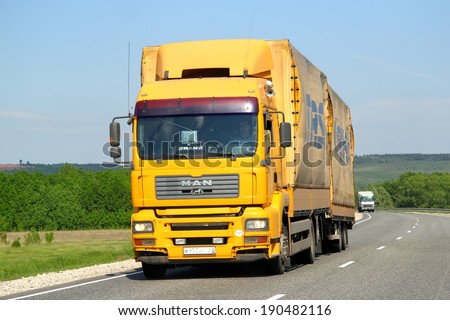 TATARSTAN, RUSSIA - MAY 29, 2013: Yellow MAN TGA semi-trailer truck at the interurban road.