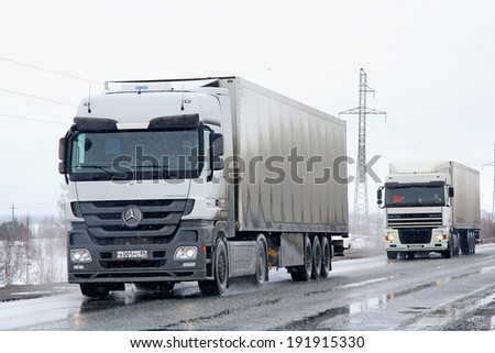 NOVYY URENGOY, RUSSIA - APRIL 21, 2013: White Mercedes-Benz Actros 1844 semi-trailer truck at the interurban road.
