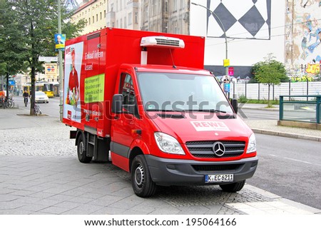 BERLIN, GERMANY - SEPTEMBER 12, 2013: Red Mercedes-Benz Sprinter cargo van at the city street.