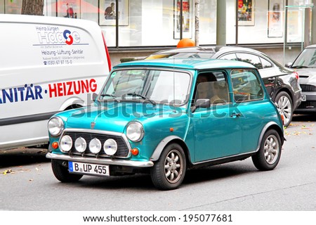 BERLIN, GERMANY - SEPTEMBER 10, 2013: Green Austin Mini Cooper retro vehicle at the city street.