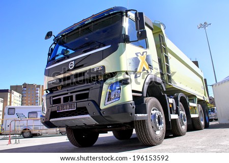 UFA, RUSSIA - MAY 28, 2014: Green Volvo FMX dump truck exhibited at the annual Autosalon Motor show.