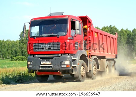 CHELYABINSK REGION, RUSSIA - JULY 12, 2008: Red MAN TGA dump truck at the gravel interurban road.