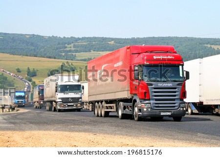 CHELYABINSK REGION, RUSSIA - JULY 19, 2008: Red Scania R420 semi-trailer truck at the interurban road.