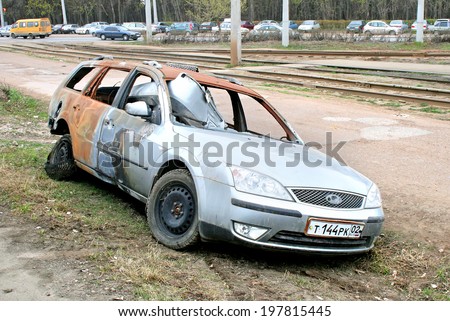UFA, RUSSIA - APRIL 24, 2008: Burnt motor car Ford Mondeo at the city street.
