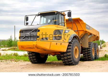 NOVYY URENGOY, RUSSIA - JUNE 24, 2014: Yellow Volvo A40F articulated dump truck at the city street.