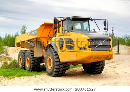 NOVYY URENGOY, RUSSIA - JUNE 24, 2014: Yellow Volvo A40F articulated dump truck at the city street.
