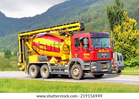 TYROL, AUSTRIA - JULY 29, 2014: Red concrete mixer truck MAN TGA at the high Alpine road.