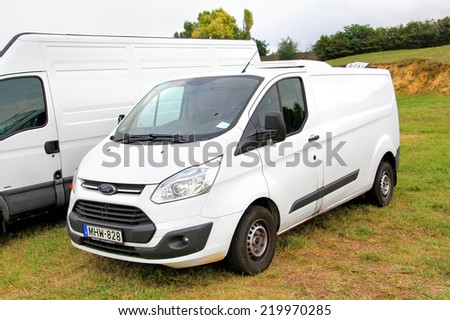 BUDAPEST, HUNGARY - JULY 27, 2014: White cargo van Ford Transit at the grass field.
