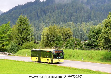 TYROL, AUSTRIA - JULY 29, 2014: Yellow suburban bus MAN A20 Lion\'s City UE at the high Alpine road.