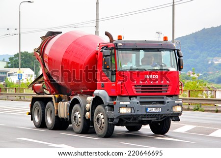 USTI NAD LABEM, CZECH REPUBLIC - JULY 21, 2014: Red concrete mixer truck Iveco Trakker at the city street.