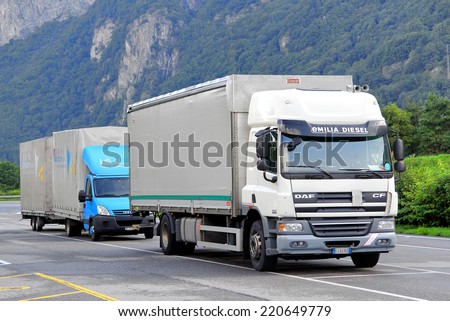 SWITZERLAND - AUGUST 5, 2014: White cargo truck DAF CF at the high Alpine mountain road.