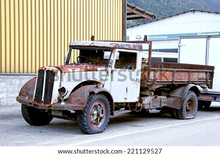 SWITZERLAND - AUGUST 5, 2014: Abandoned retro truck Saurer at the roadside in a little Alpine village.