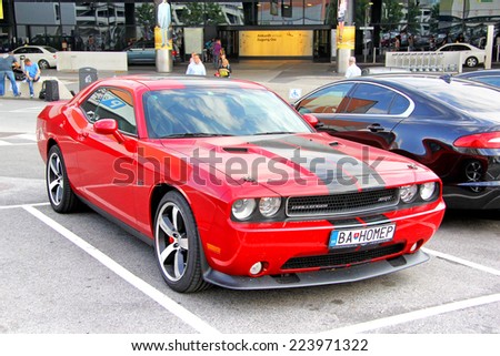VIENNA, AUSTRIA - JULY 24, 2014: Red sports car Dodge Challenger SRT at the parking of the Vienna International Airport.