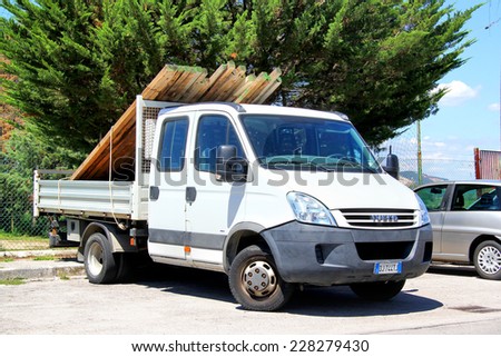 GROSSETO, ITALY - AUGUST 1, 2014: White cargo truck Iveco Daily at the city street.