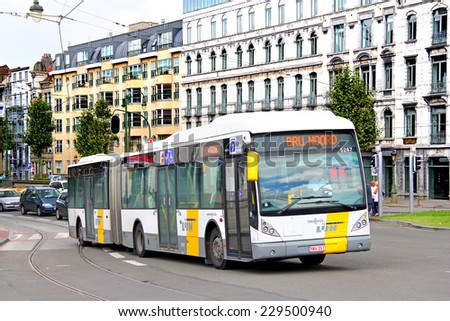 BRUSSELS, BELGIUM -  AUGUST 9, 2014: Modern articulated city bus Van Hool AG300 at the city street.