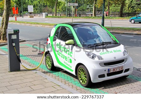 BRUSSELS, BELGIUM - AUGUST 9, 2014: Modern electric minicar Smart Fortwo charging at the city street.