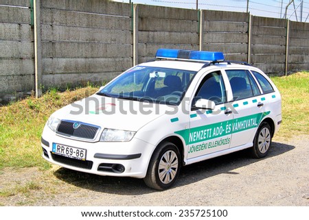 BUDAPEST, HUNGARY - JULY 25, 2014: White police car Skoda Fabia at the countryside.