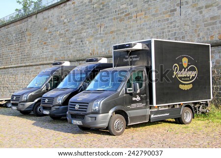 DRESDEN, GERMANY - JULY 20, 2014: Black cargo vans Volkswagen Crafter at the city street.
