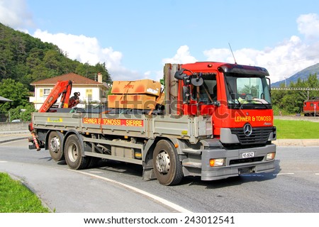 VALAIS, SWITZERLAND - AUGUST 5, 2014: Old red flat-bed truck Mercedes-Benz Atego at the interurban road.