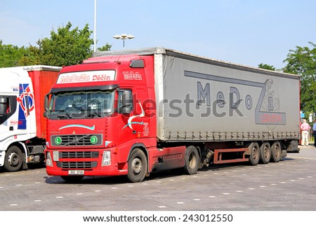 BRANDENBURG, GERMANY - JULY 20, 2014: Red semi-trailer truck Volvo FH12.460 at the parking near the interurban freeway.