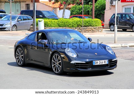 SAINT-TROPEZ, FRANCE - AUGUST 3, 2014: Black sports car Porsche 991 911 at the city street.