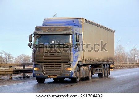BASHKORTOSTAN, RUSSIA - MARCH 11, 2015: Very dirty semi-trailer truck DAF XF at the interurban road.