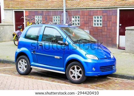 AMSTERDAM, NETHERLANDS - AUGUST 10, 2014: Tiny blue car Mountain at the city street.