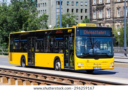 DRESDEN, GERMANY - JULY 20, 2014: Yellow city bus MAN A21 Lion\'s City at the city street.