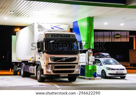 TYROL, AUSTRIA - JULY 28, 2014: White cargo truck Volvo FM at the gas station.