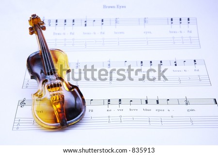 mini violin on music notation