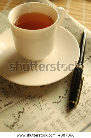 Evening tea over business newspaper