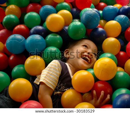 Little boy having fun time in balls pool