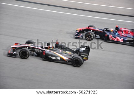 SEPANG, MALAYSIA - APRIL 4, 2010: Hispania Racing and Red Bull Racing battle for position in Formula 1 Petronas Malaysian Grand Prix on April 4, 2010 in Sepang, Malaysia