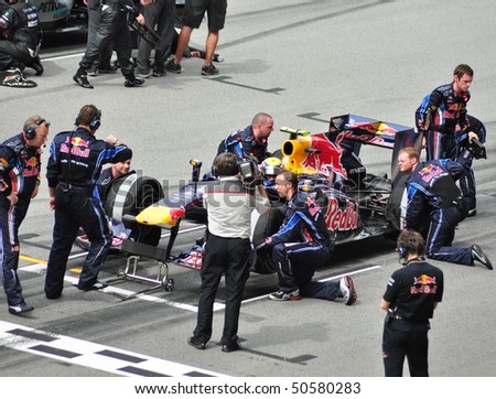SEPANG, MALAYSIA - APRIL 4: Pit crews prepare Mark Webber\'s car of Red Bull Racing Team at Malaysian F1 Grand Prix April 4, 2010 at Sepang International Circuit in Malaysia.