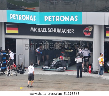 SEPANG, MALAYSIA - APRIL 3: Pit crews prepare Michael Schumacher\'s car at  Qualifying Session of Malaysian F1 Grand Prix April 3, 2010 at Sepang International Circuit in Malaysia.
