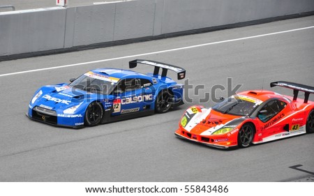 SEPANG, MALAYSIA - JUNE 20 : Super GT drivers in battle for position during the Super GT International Series, Round 4 on June 20, 2010 in Sepang International Circuit, Malaysia.