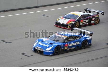 SEPANG, MALAYSIA - JUNE 20 : Super GT drivers in battle for position during the Super GT International Series, Round 4 on June 20, 2010 in Sepang International Circuit, Malaysia.