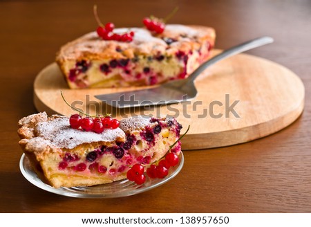 Closeup fresh berries tart on wooden background