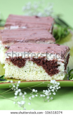 Zucchini cake with vanilla cream and chocolate sour cream glaze. Shallow dof