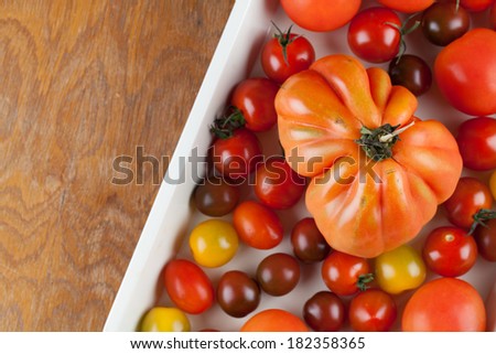 Yellow, red and black tomatoes on baking sheet