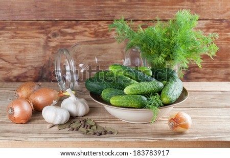 Bowl with fresh cucumbers, dill, garlic, onion, bay leaf and allspice Ã?Â¢?? ingredients for pickle making