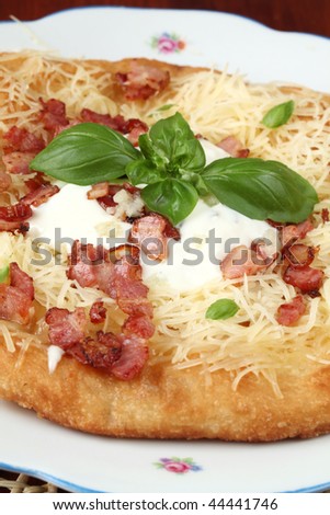 Langos, traditional Hungarian pancake with cheese, bacon, and garlic