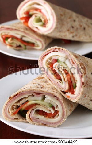 Wholemeal tortillas with ham, cheese, tomatoes, cucumber and cabbage