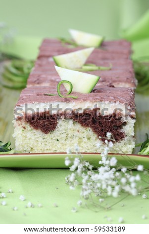 Zucchini cake with vanilla cream and chocolate sour cream glaze. Shallow dof