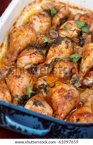 Roast chicken drumsticks on a baking pan, fresh out of the oven