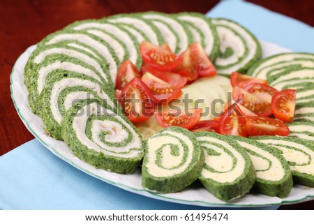 Two kinds of spinach rolls,  with eggs and cheese and with garlic cheese and ham. Shallow dof