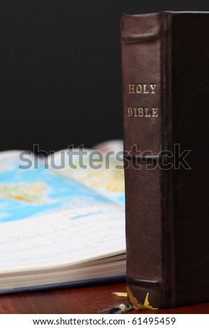Holy Bible and a world map in the background. World missions concept. Copy space.