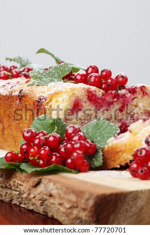 Homemade sponge cake with fresh organic red currants and sugar icing
